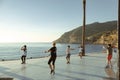 Albir, Spain - April 26, 2023: Active people exercise in the morning in Albir seaside beach promenade. Albir is