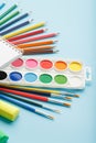An album for drawing and creativity for school with stationery, a palette of colored paints, markers, brushes and pencils Royalty Free Stock Photo
