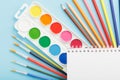 An album for drawing and creativity for school with stationery, a palette of colored paints, markers, brushes and pencils Royalty Free Stock Photo