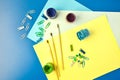 Album pages and paints gouache, brush on a blue background, office supplies, copy space Royalty Free Stock Photo
