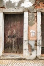 Chipped facade with old brown wooden door Royalty Free Stock Photo