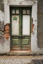 Chipped facade with old green wooden door Royalty Free Stock Photo