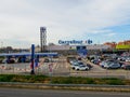 ALCALA DE HENARES, SPAIN; JANUARY 2, 2022: CARREFOUR FRENCH BRAND SUPERMARKET WITH A PARKING LOT IN FRONT OF IT