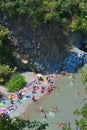 ALCANTARA, ITALY - AUGUST, 2015: People enjoy ice-cold water of Alcantara river in the Alcantara river park in August, 2015 in Sic