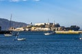 Alcatraz Island on the blue sea with sailing ships in San Francisco, California