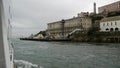 Alcatraz island in San Francisco Bay, California USA. Federal prison for gangsters on rock, foggy weather. Historic jail, cliff in Royalty Free Stock Photo