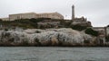 Alcatraz island in San Francisco Bay, California USA. Federal prison for gangsters on rock, foggy weather. Historic jail, cliff in Royalty Free Stock Photo