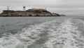 Alcatraz island in San Francisco Bay, California USA. Federal prison for gangsters on rock, foggy weather. Historic jail, cliff in Royalty Free Stock Photo