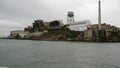 Alcatraz island in San Francisco Bay, California USA. Federal prison for gangsters on rock, foggy weather. Historic jail, cliff in Royalty Free Stock Photo