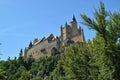 Alcazar Castle Seen From The River That Runs Through The Valley That Reigns In Segovia Slightly Caught By A Small Grove. Architect Royalty Free Stock Photo