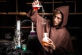 Alchemist in chemical laboratory prepares magical liquids
