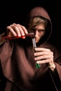 Alchemist in chemical laboratory prepares magical liquids