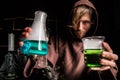 Alchemist in chemical laboratory prepares magical liquids