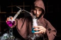 Alchemist in chemical laboratory prepares magical liquids Royalty Free Stock Photo