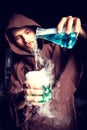 Alchemist in chemical laboratory prepares magical liquids