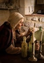 Alchemist in her medieval kitchen