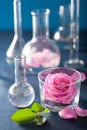 alchemy and aromatherapy set with rose flowers and chemical flasks