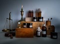 Alchemy lab. bottles, jars, scales, candle on wooden shelves