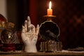 Alchemy Palmistry hand model for fortune telling palm reading and other magical items in candlelight Royalty Free Stock Photo