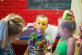 Alchevsk, Ukraine - August 3, 2017: A child draws a face for a children`s party. Aqua makeup for girls and boys.