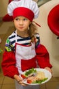 Alchevsk, Ukraine - July 30, 2017: School cooks for children. Learn to cook pasta with sausages