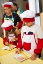 Alchevsk, Ukraine - July 30, 2017: School cooks for children. Learn to cook pasta with sausages