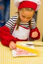 Alchevsk, Ukraine - July 30, 2017: School cooks for children. Learn to cook pasta with sausages