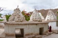 Monk among ancient stupas chortens in the form of arches-entrances in the Buddhist monastery of Alchi in Ladakh Royalty Free Stock Photo