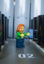 Alcobendas, Spain July 20, 2019: Female technician working in a corridor of a data processing center, Studio shot of Lego