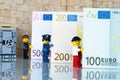 Alcobendas, Spain - May 14, 2018: LEGO minifigures holding bills background, Lego minifigures are manufactured by The Lego Group