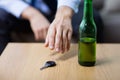 Drunk driver hand taking car key from table Royalty Free Stock Photo