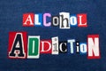 ALCOHOL ADDICTION text word collage, colorful fabric on blue denim, abuse and treatment concept