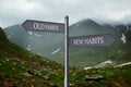 Alcohol addiction: what to choose - life with old bad habits or new good ones? Signpost with different directions against mountain Royalty Free Stock Photo