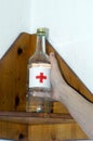 Alcohol bottle, symbol for alcoholism and drinking problem