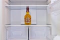 Alcohol bottles whiskey Chivas Regal in empty fridge - Moscow, Russia, January 06, 2021