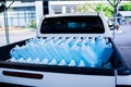 Alcohol for cleaning and sanitizing is contained in gallons on pick-up truck. Many gallon alcohol gel for sanitizing Coronavirus