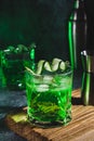 Alcohol cocktail with cucumber in whiskey glass with ice cubes. Summer spirit drink and shaker Royalty Free Stock Photo