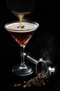 Alcohol cocktail Espresso Martini cocktails garnished with coffee beans, beans in espresso holder in smoke Royalty Free Stock Photo