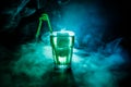 Alcohol cocktail in glass with ice in smoke on dark background. Club drinks concept. One glass of cocktail. Selective focus Royalty Free Stock Photo