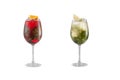 Alcohol cocktail with mint, fruit and berries on a white background. A set of two cocktails in glass goblets on a long leg Royalty Free Stock Photo