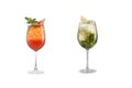 Alcohol cocktail with mint, fruit and berries on a white background. A set of two cocktails in glass goblets on a long leg Royalty Free Stock Photo