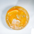 Alcohol cocktail with orange and ice top view
