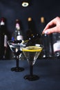 Alcohol cocktail with splash.Dry martini with black olives.Vermouth cocktail inside martini glass over dark background.Martini gla Royalty Free Stock Photo