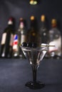 Alcohol cocktail with splash.Dry martini with black olives.Vermouth cocktail inside martini glass over dark background.Martini gla Royalty Free Stock Photo