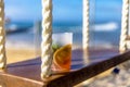 Alcohol cocktail of tropical drink on a swing overlooking the caribbean sea in the Mayan Riviera of Mexico Royalty Free Stock Photo