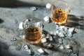An alcohol drink and ice. Whisky with pieces of ice.Glasses with a strong beverage Royalty Free Stock Photo
