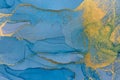 Alcohol ink blue and gold abstract background. Ocean style watercolor texture.