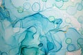 Alcohol ink blue handdrawn watercolor drops on white background. Bubbles imitation.