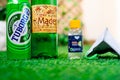 Alcohol liquor wine beer placed on grass at the entrance of house with mask and sanitizer showing home delivery of