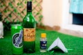 Alcohol liquor wine beer placed on grass at the entrance of house with mask and sanitizer showing home delivery of